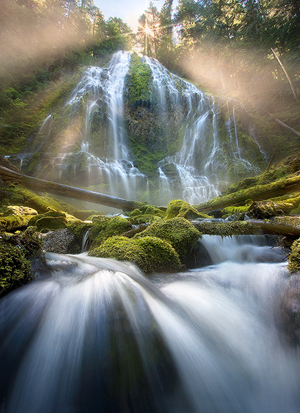 Sun beams through the mist created by the massive Proxy Falls in the central Oregon Cascade Range.