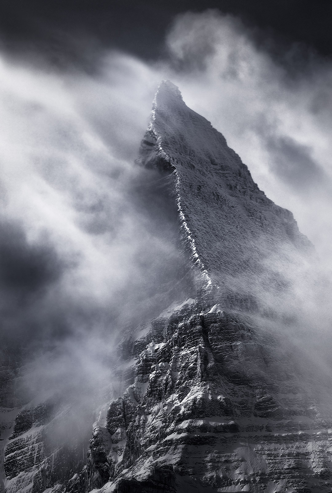 Mount Assiniboine, cutting through the clouds after a clearing winter storm.&nbsp;