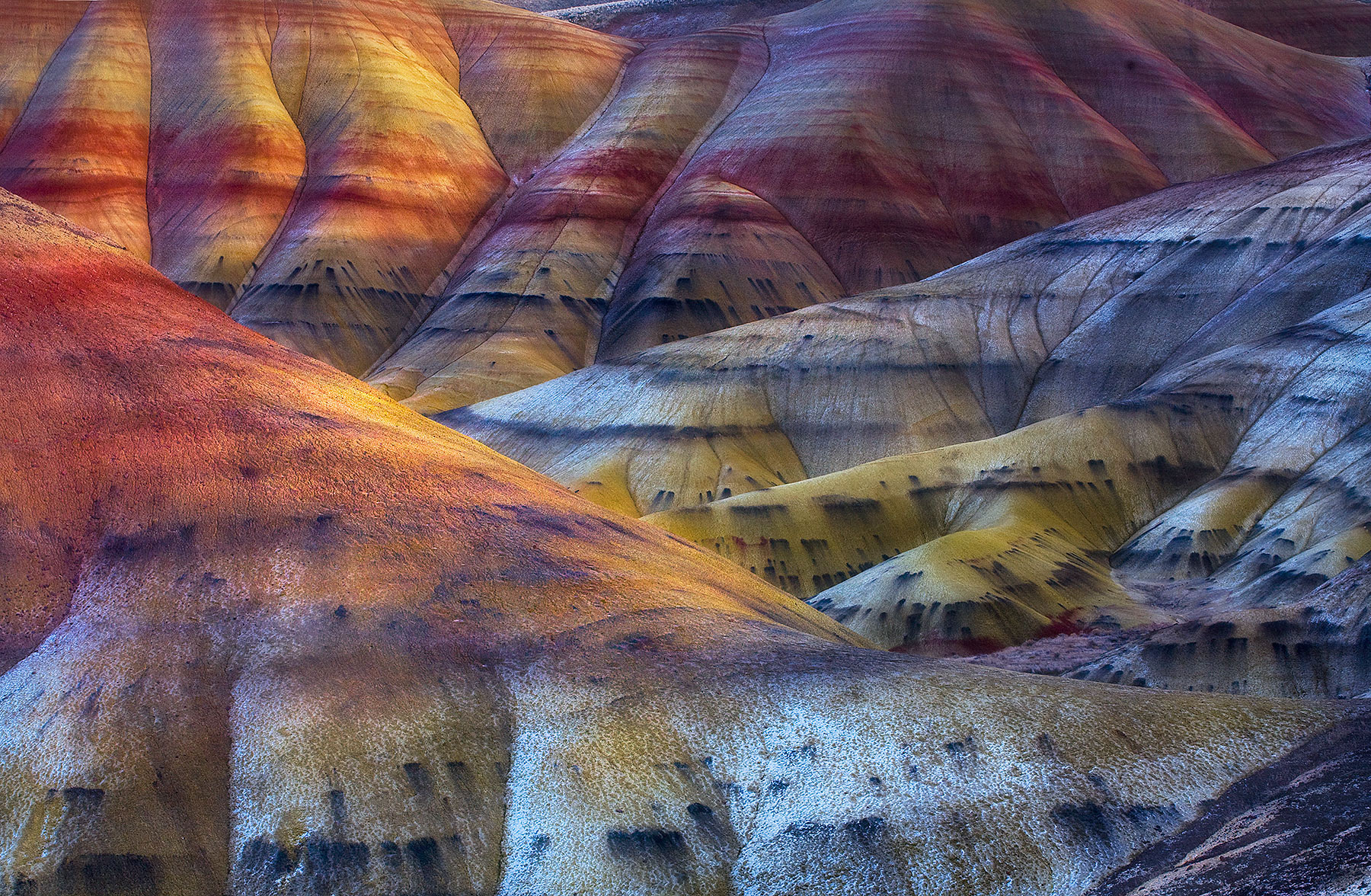 Amazing colors in Oregon's Painted Hills dusted with a bit of fresh snow and filtered evening light.