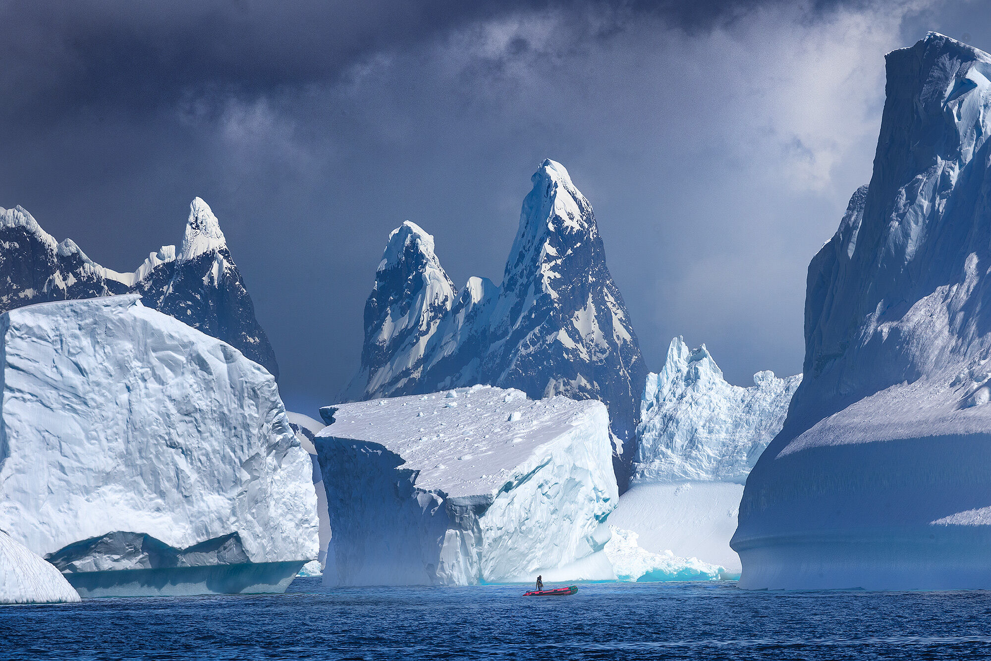 This dramatic view of our zodiac reminded me of enormous buildings in a city, but made entirely of rock and ice.  Antarctica...