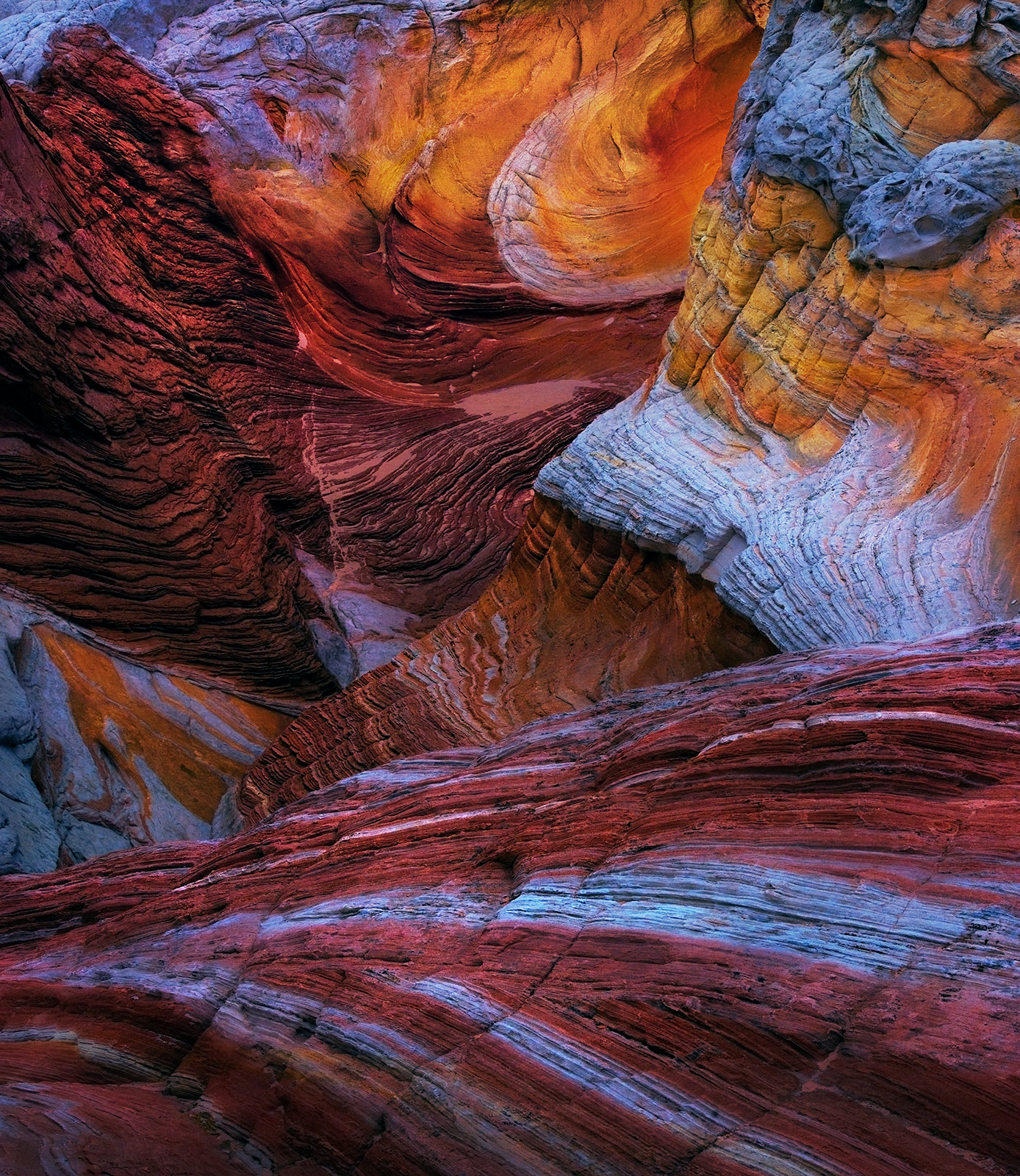 Swirls of Arizona sandstone with lighting emphasized.