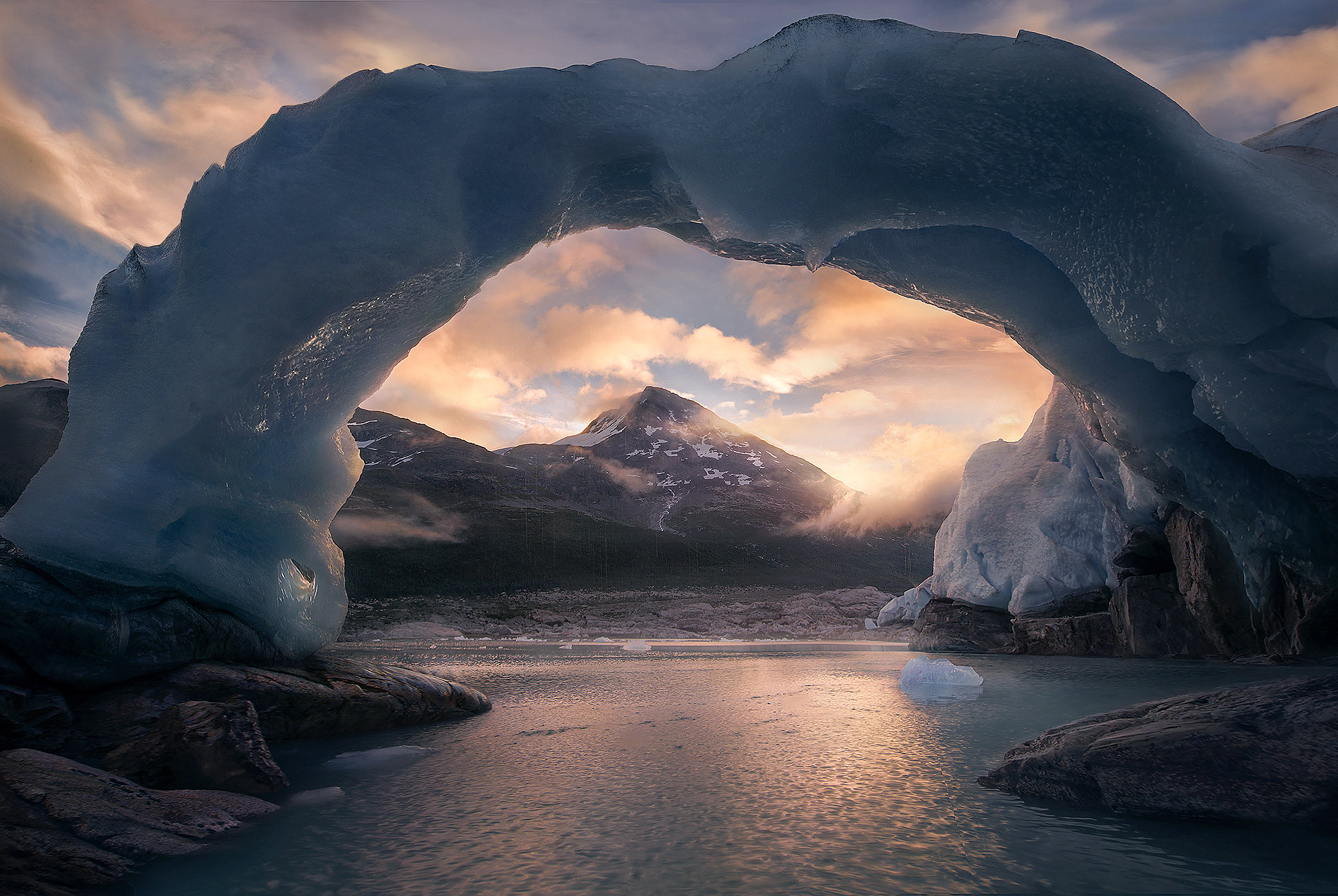 A 50ft-high, 50ft-wide arch made entirely out of Glacial Ice captured here at sunrise from a raft I used to float this lake while...