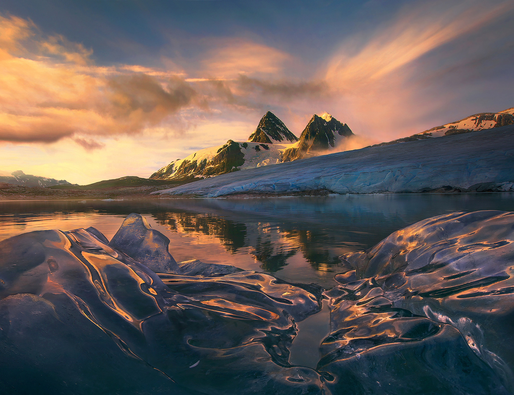 Shiny icebergs photographed from an inflatable kayak while heli-backpacking these remote mountains.&nbsp;