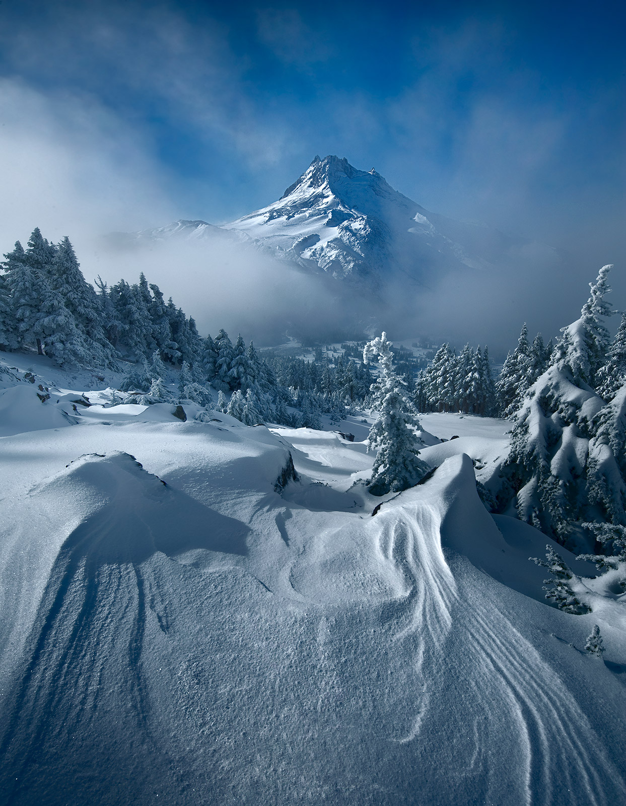 Oregon's Mount Jefferson peeks out of the clouds near my alpine campsite early in the morning following the season's first snowfall...