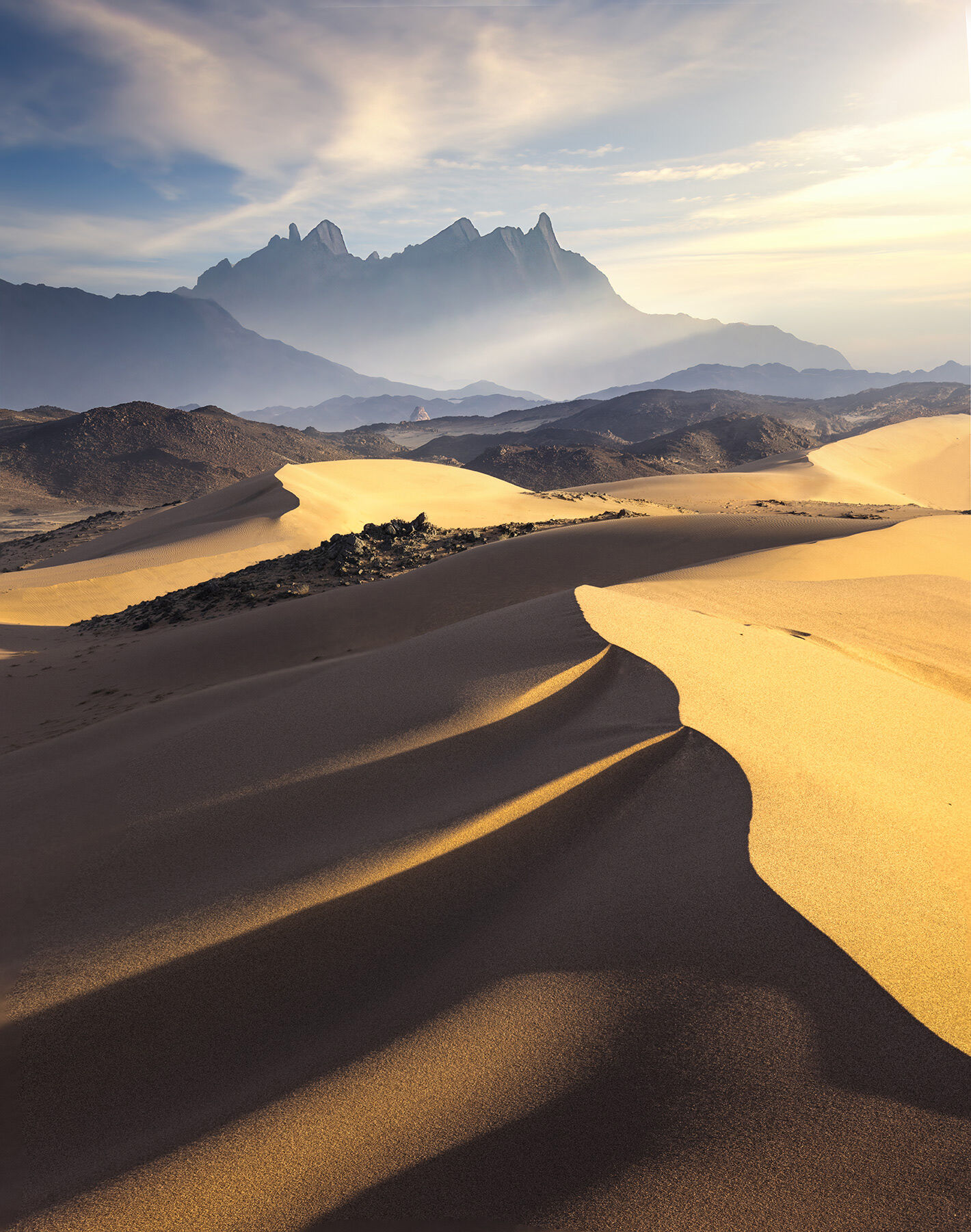 The interplay of dunes, light and high peaks in Saudi Arabia's Neom region.