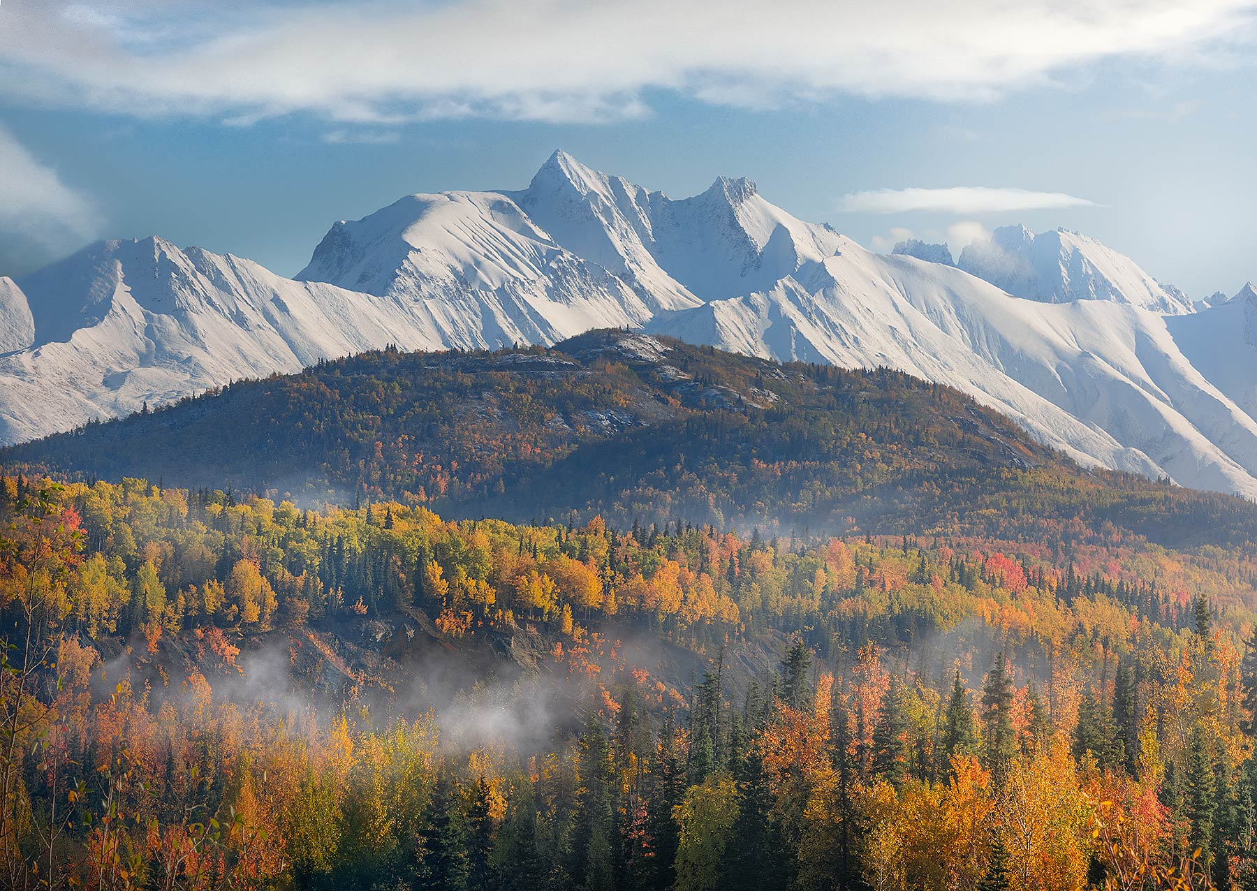 Big snowy Alaskan peaks and fall colors after a storm.