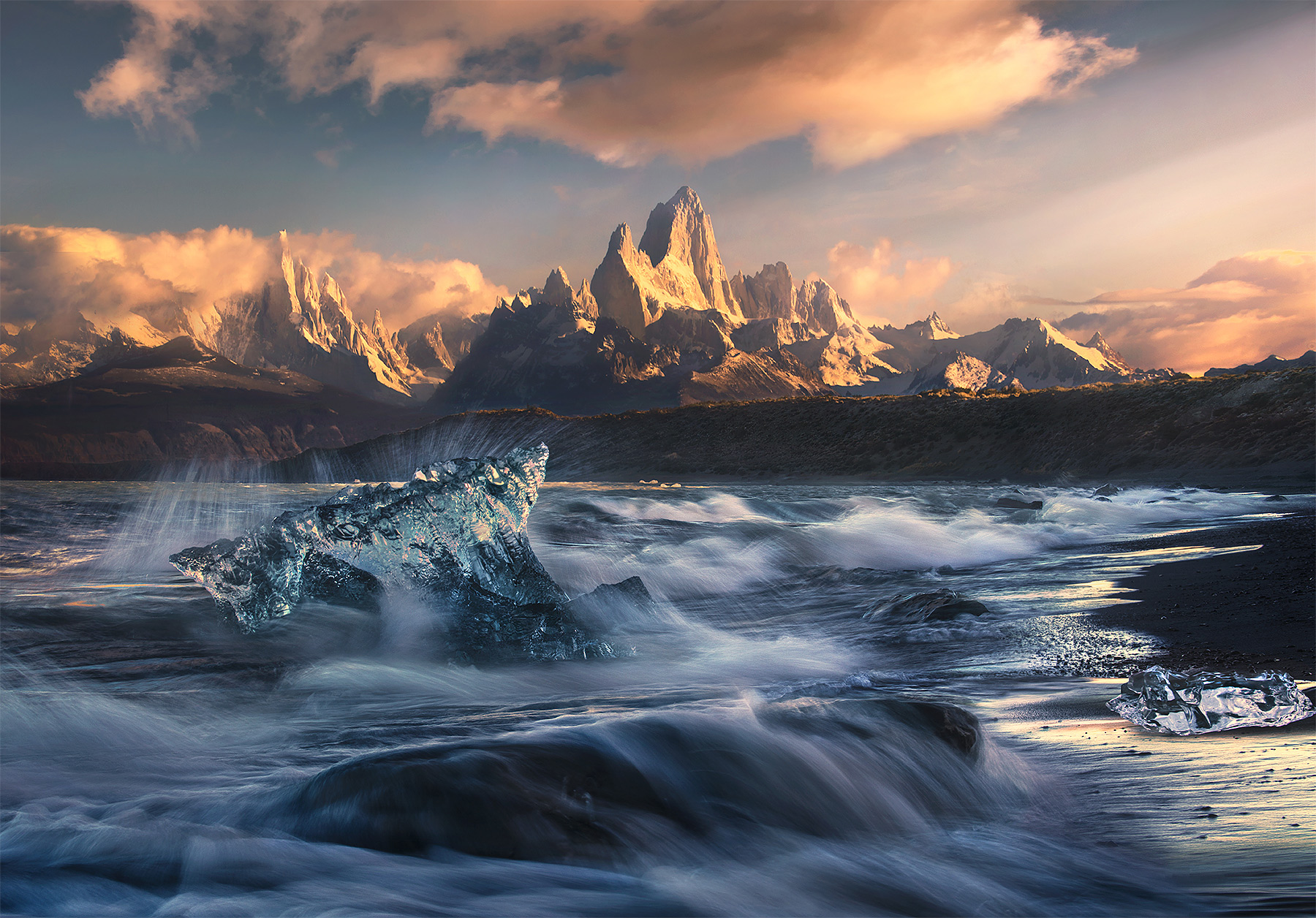 A unique view of Fitz Roy and Cerro Torre from a distant lakeshore catching some big wave action and a few icebergs one beautiful...