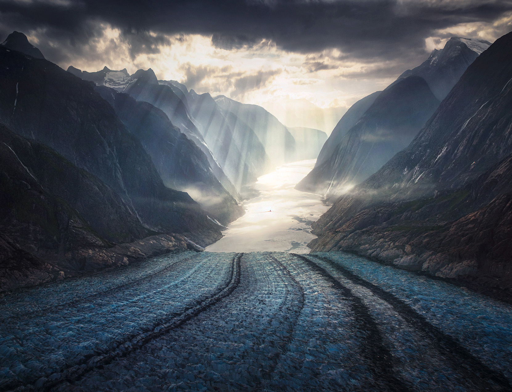 This glacier has receded 8 miles in 50 years.   Warmth beams through as a tiny vessel sails through the fiord into the sun.