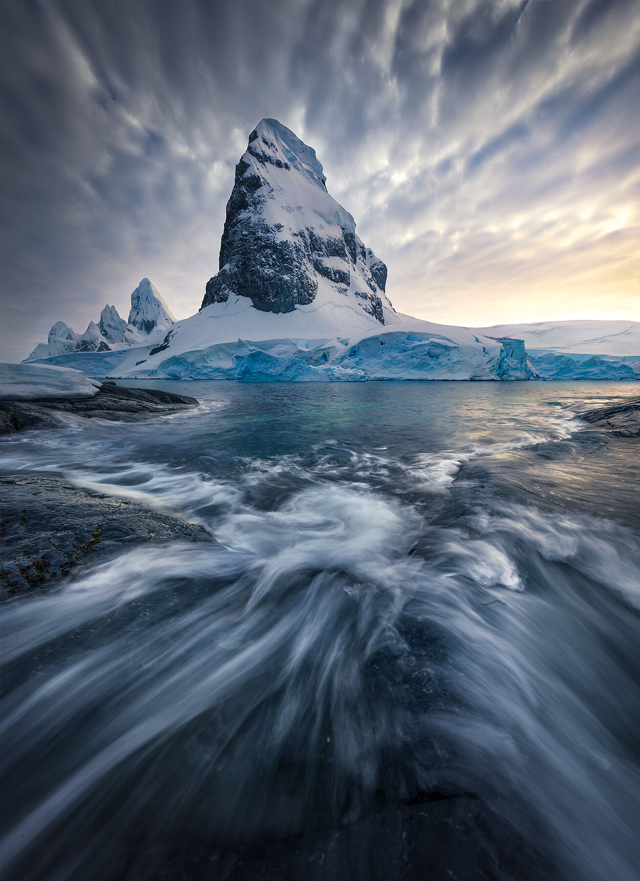 Antarctica is home to the most amazing coastal mountains on the planet.  Here's one from a small island and rushing waves one...