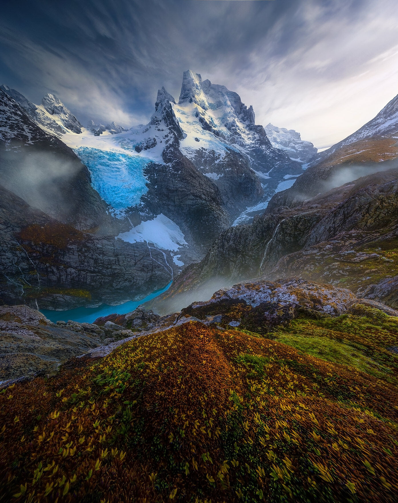 A super wide angle lens shows off dramatic peaks and colorful mosses of the Patagonian Fjords.  In between we see layers of turquoise...