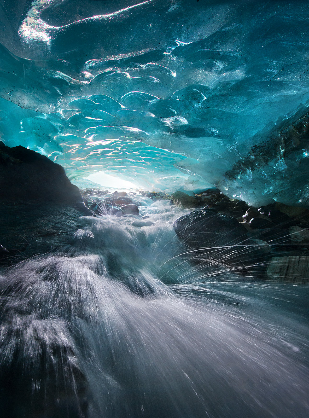 Ice Action (2012) One of the raging-fast, cold and wet passageways I photographed while climbing through an extensive network of glacial blue-ice...