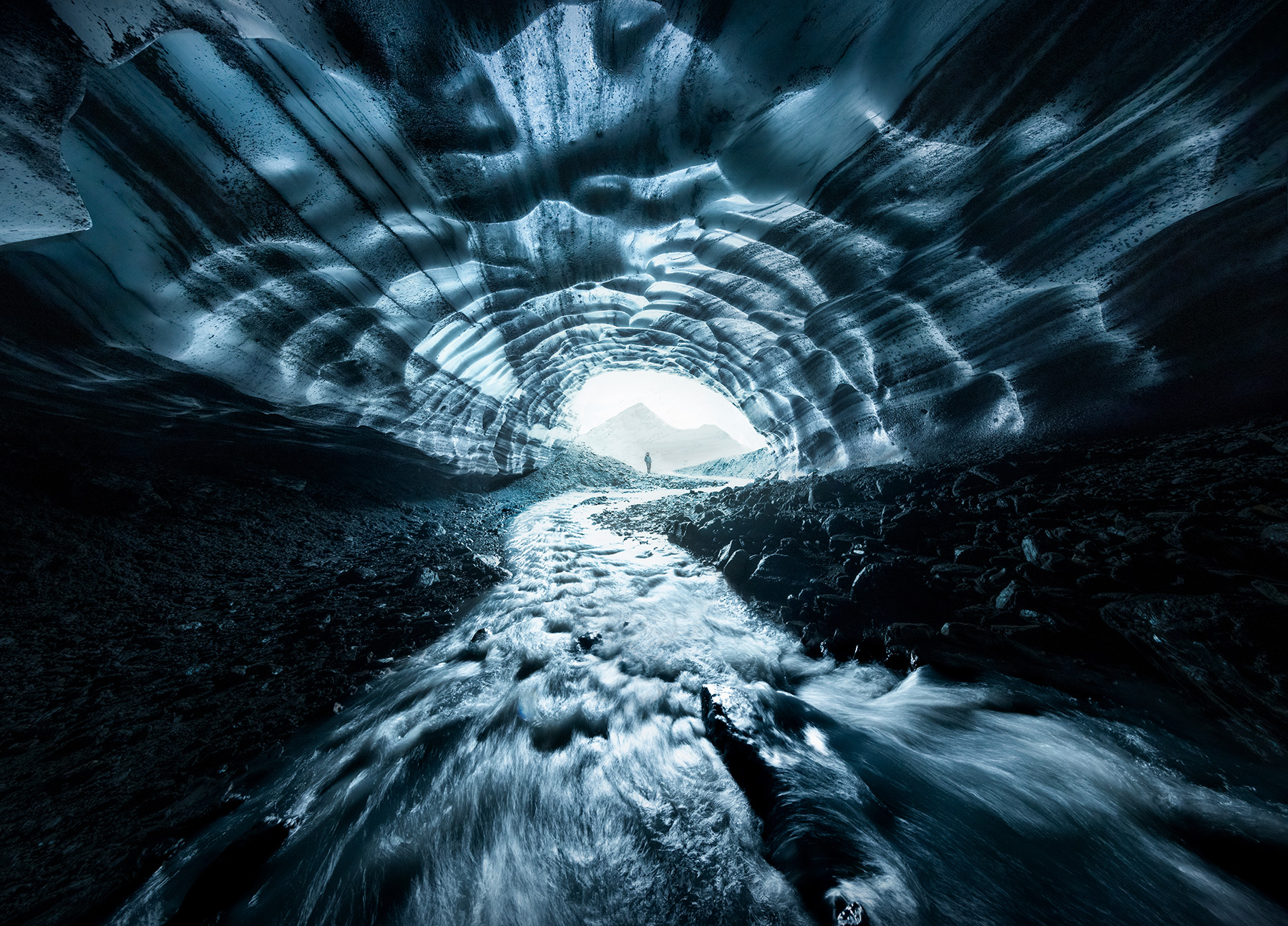An amazing ice cave with incredible stripes shot through a wide angle lens during a brief helicopter detour on our fall colors...