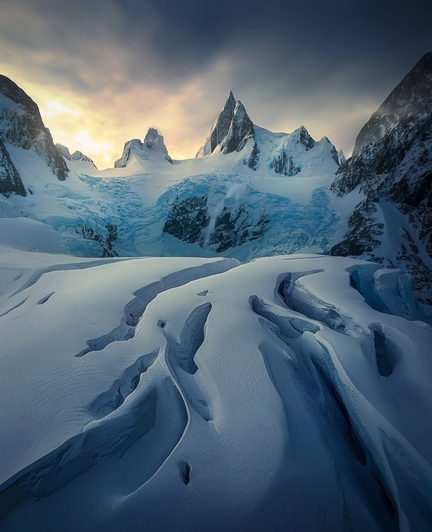 Glacial crevasses extend outward towards the jagged peaks deep within Patagonian Fjords, Chile