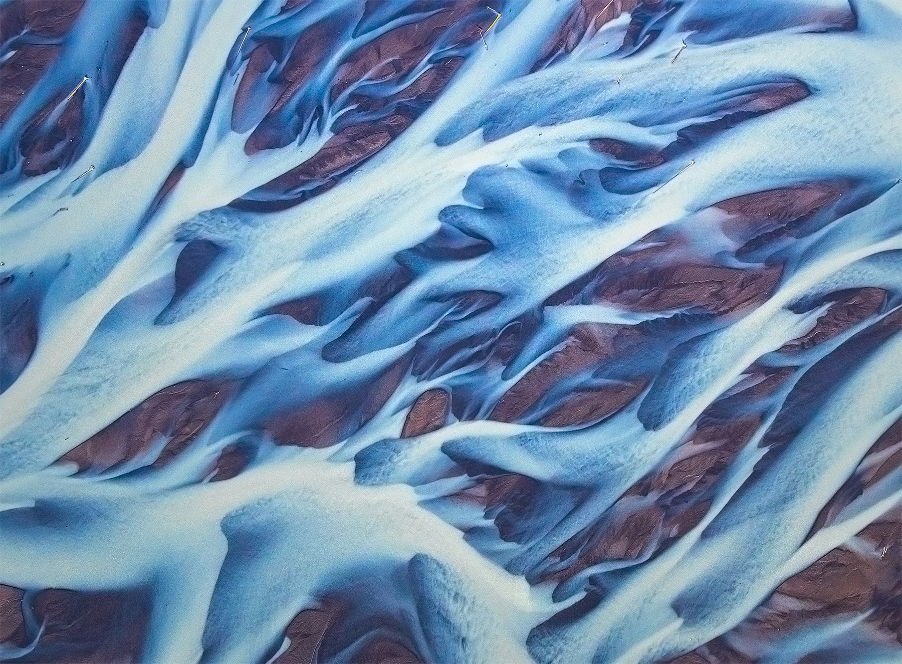 An aerial abstract of braided glacial rivers.  Luckily Alaska does not have black sand.
