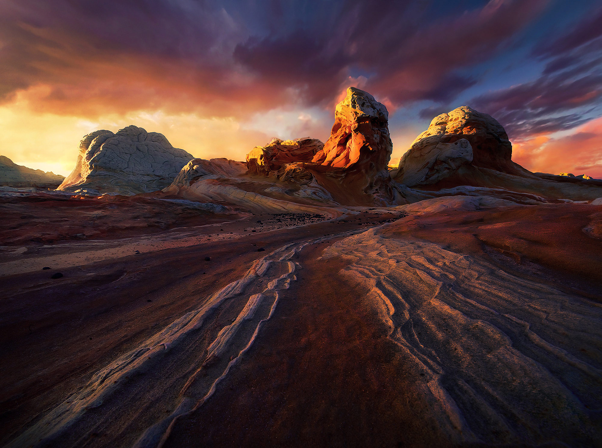 Explosive sunset light and dark, dramatic skies over sandstone formations in Arizona.