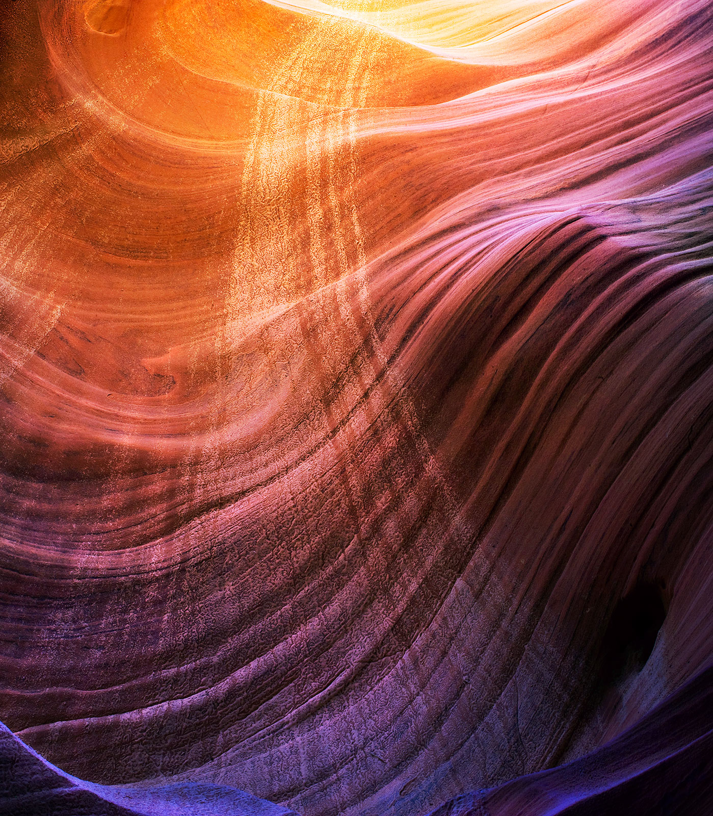 The curvature of sandstone waves deep inside a remote slot canyon are complimented by the opposite lines left behind by an occasional...