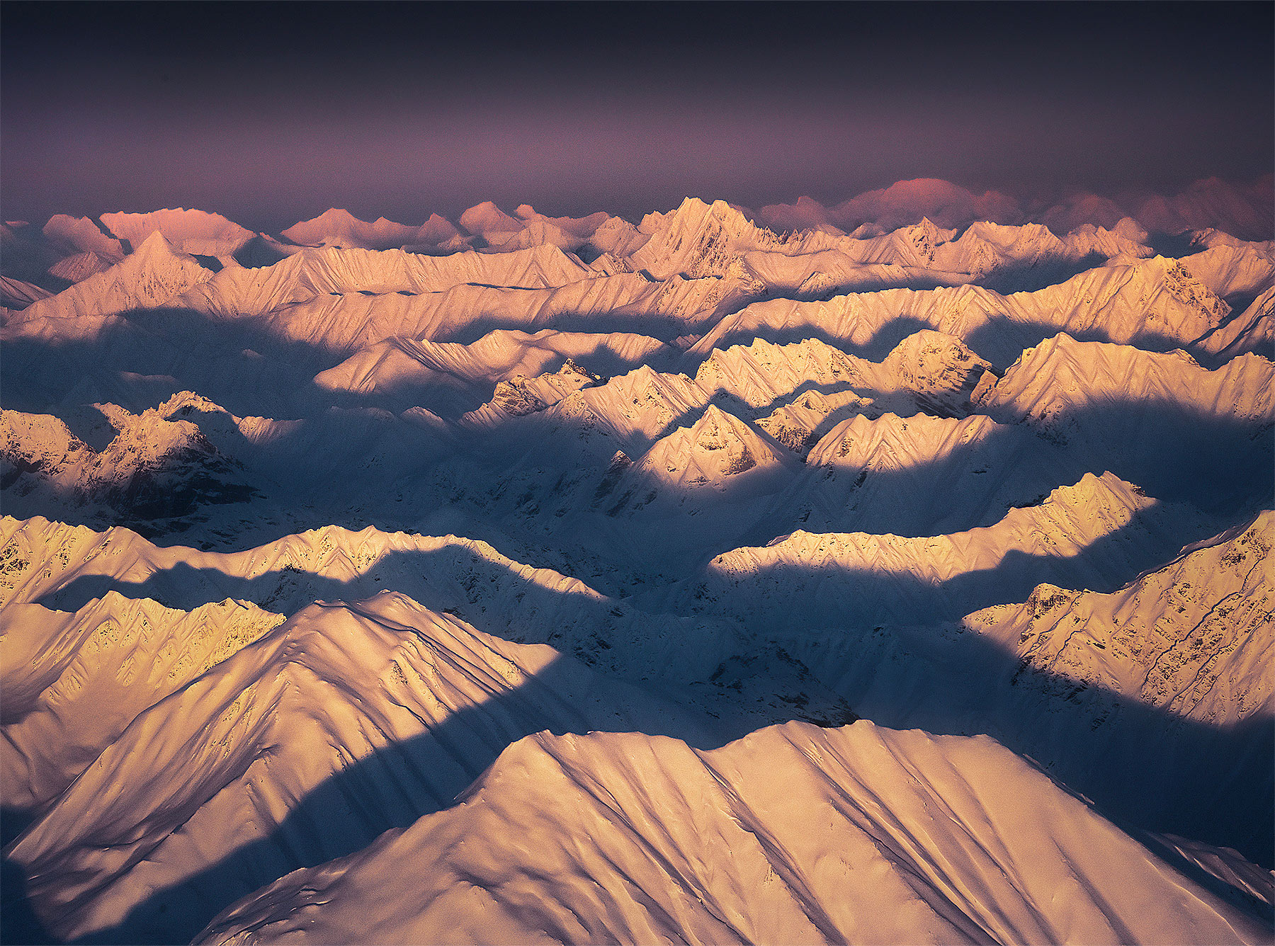 Endless layers of mountains at sunset from a bush plane over Denali National Park, Alaska