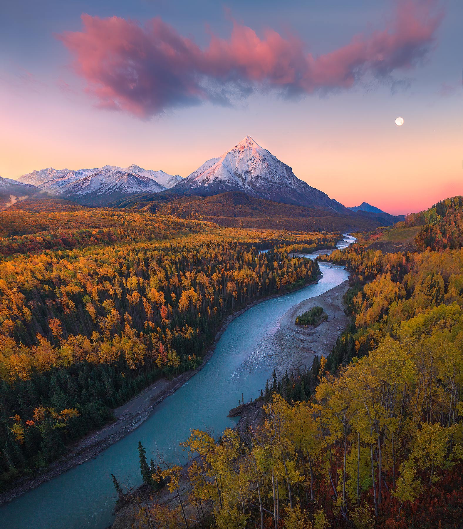 A full moonset at dawn over blue glacial rivers and spectacular fall colors.  Alaska, of course.