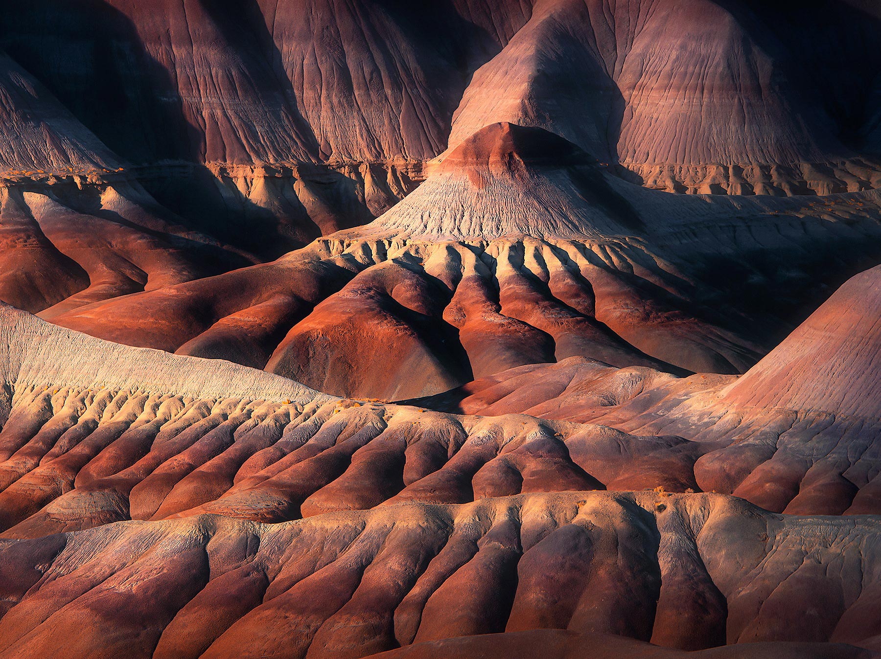Layered badlands catch the sunset light.