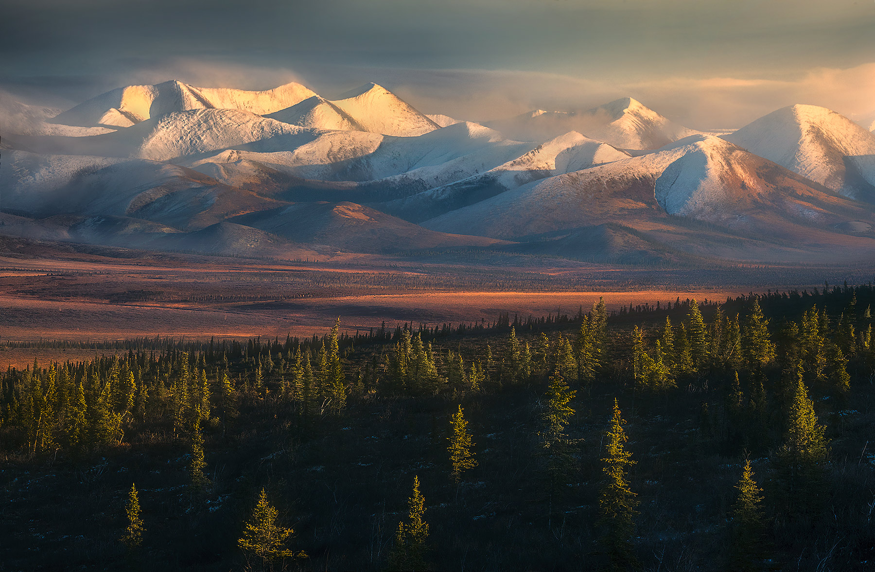 Richardson The Richardson Range lies in the Far North of Canada's Yukon, above the Arctic Circle. Here, soft light fades through high clouds...