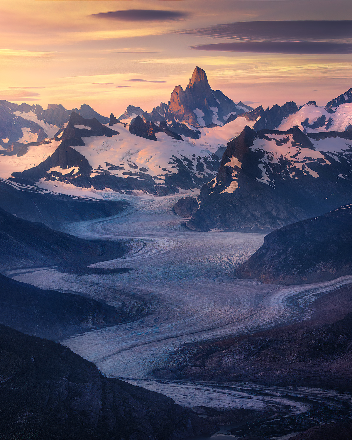 Miles of curving rivers of ice flow down towards the sea from the heights of Devil's Thumb, an amazing summit in the Southern...