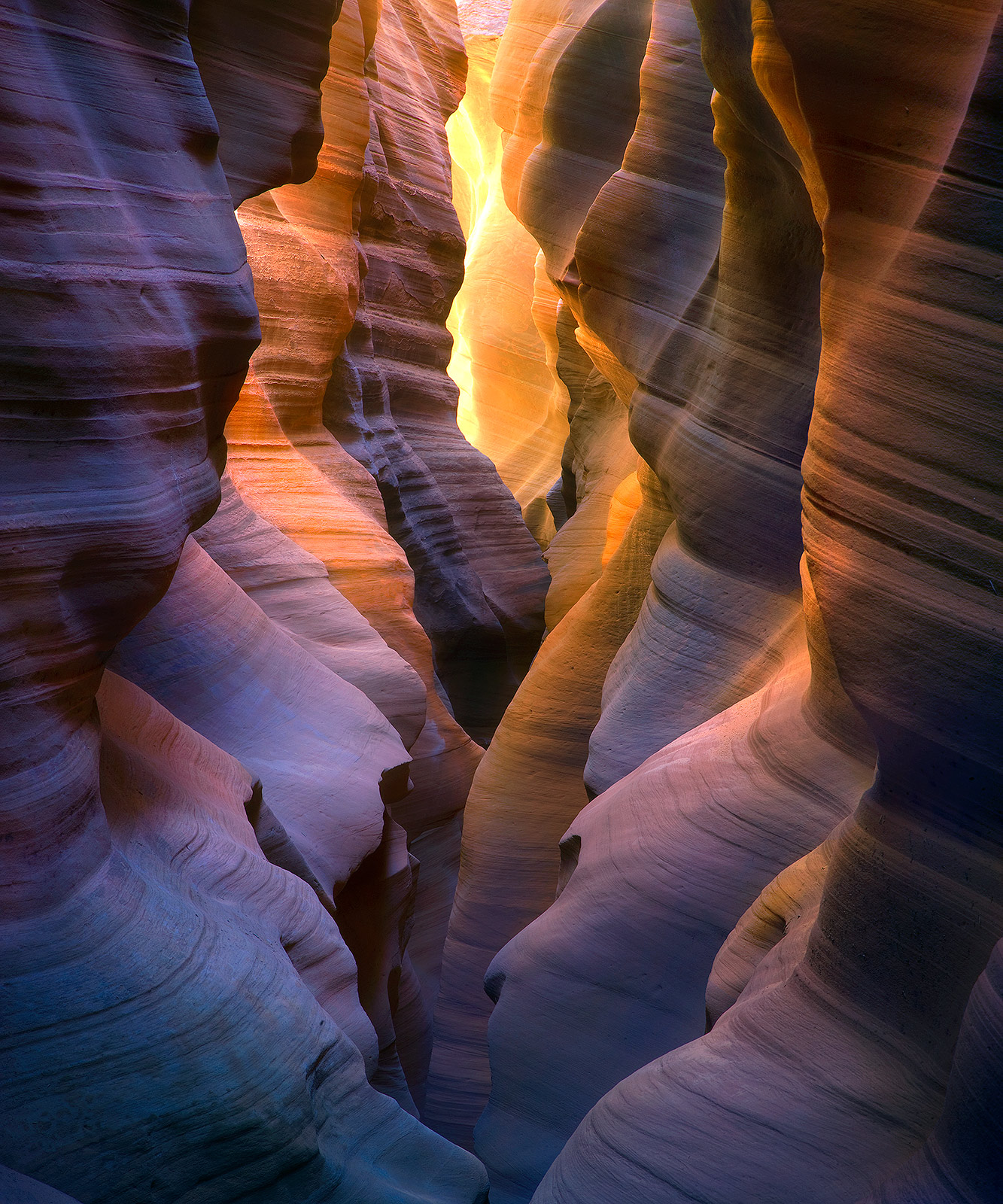 Colorful reflected light in a remote slot canyon environment. The various rich colors and hues present here are the result of...