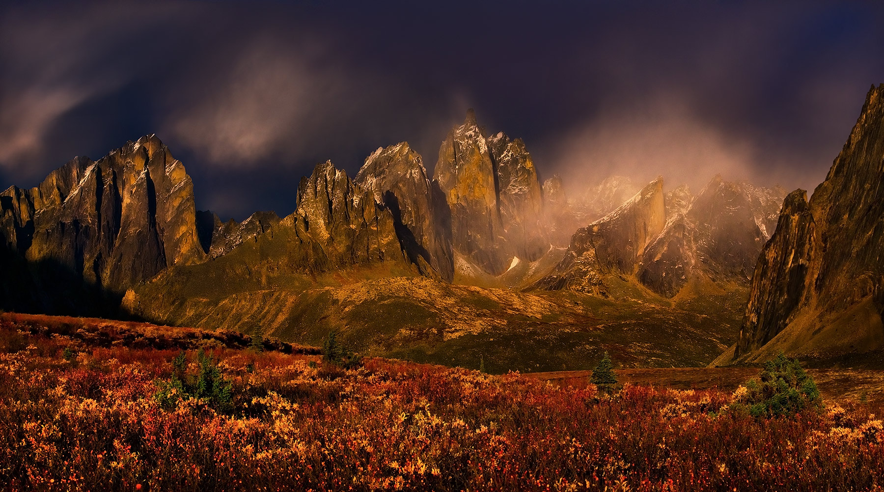 Stone of Ages (2011) Dramatic light over the great peaks of the Ogilvie Mountains amidst rich Autumn colors. Yukon territory, Canada. The photograph...