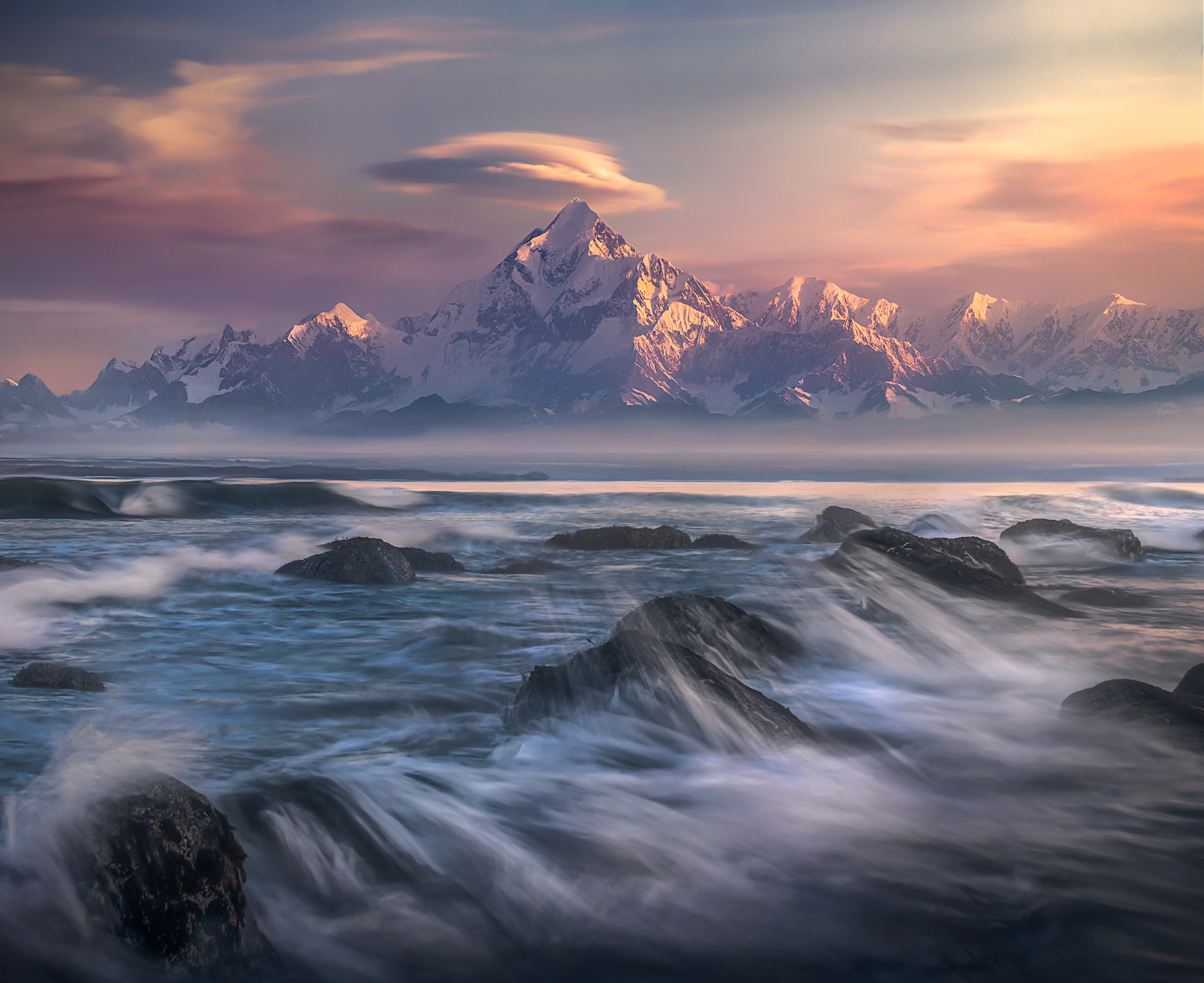 The great Mt St Elias rises over eighteen thousand feet above crashing surf in Alaska, some of the greatest vertical relief in...