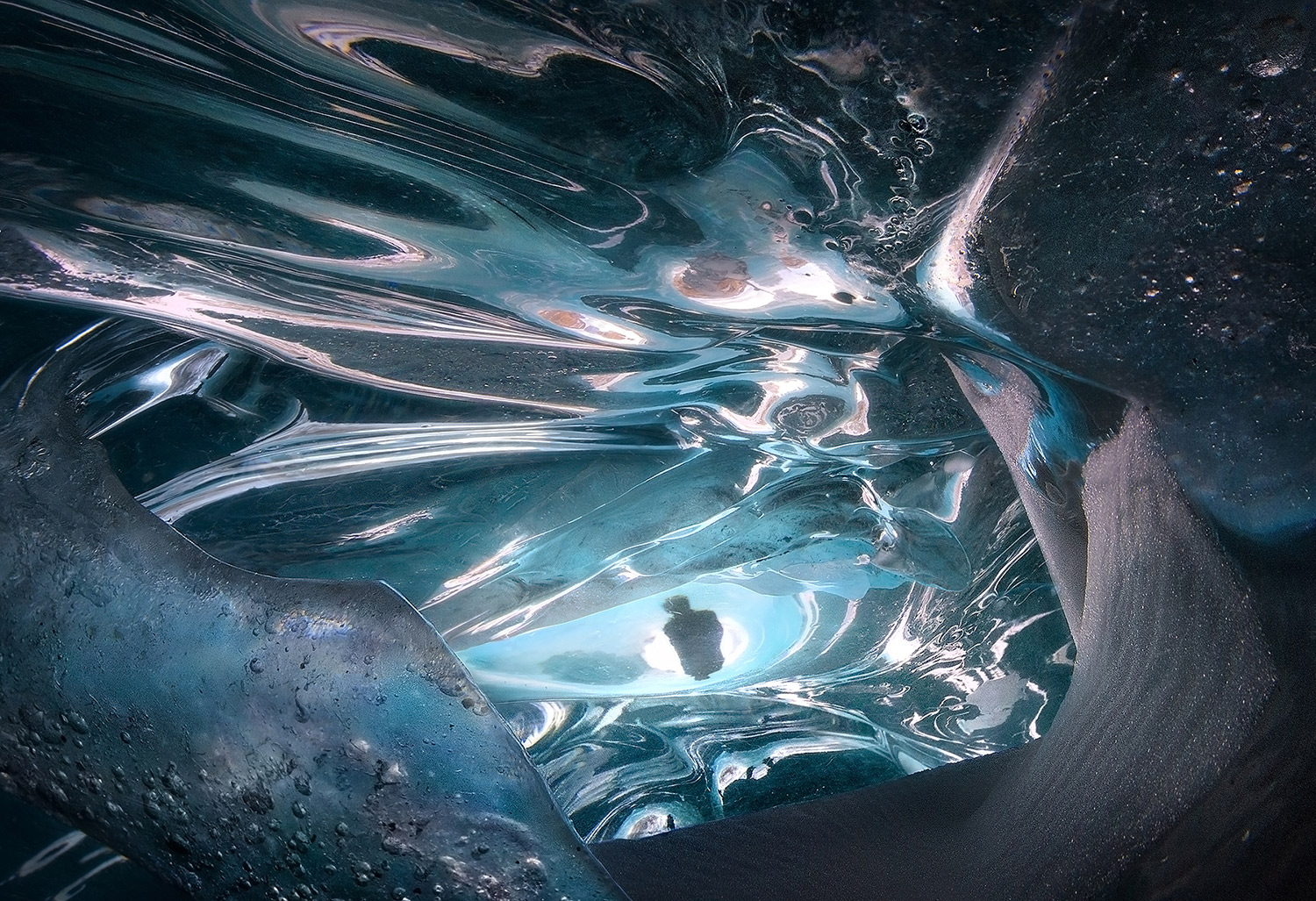 A mirror of mirrors of a shadow inside an ice cave.&nbsp;