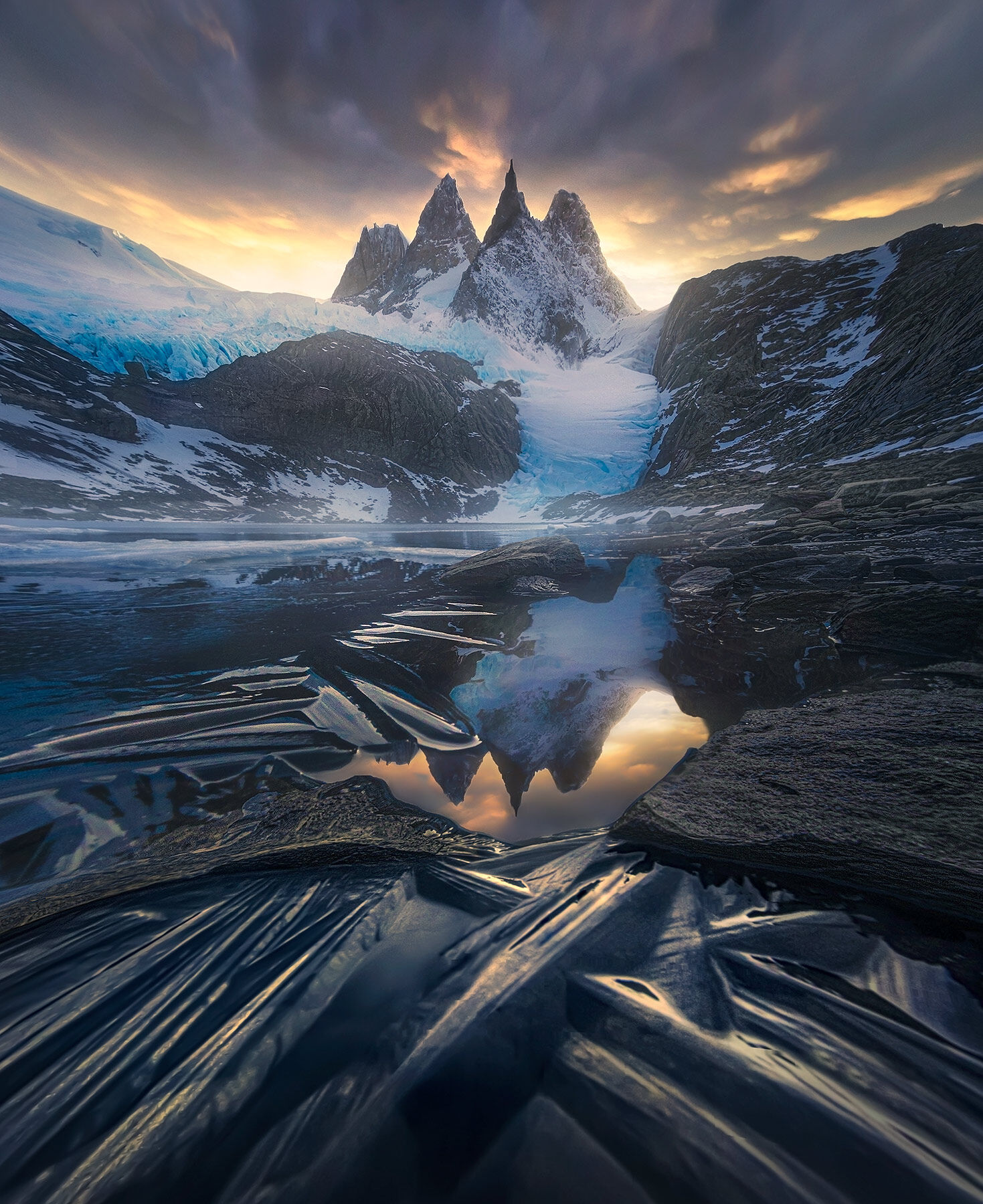 Icy peaks above and ice crystals on the lake below frame the big glaciers high in the amazing Patagonian Fjords