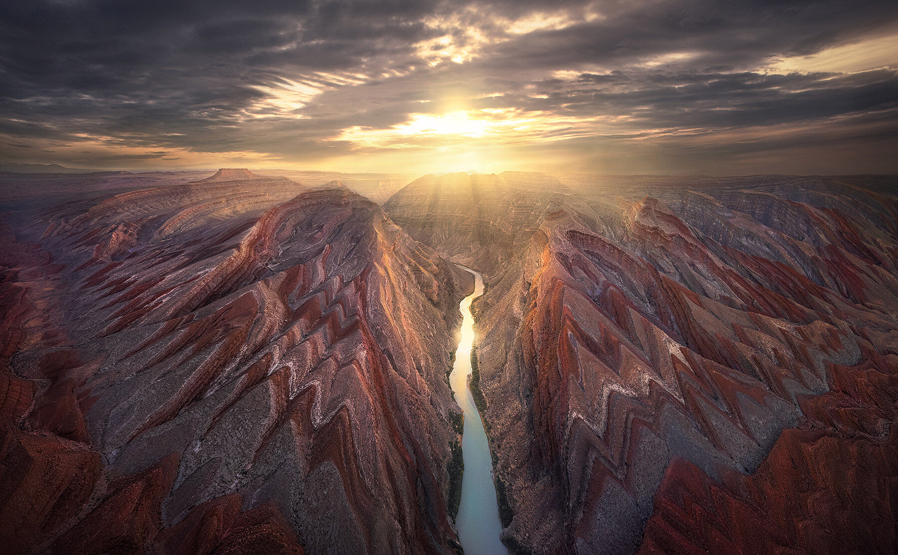 The river carves its way through some amazing geological formations seen from a thousand feet above the Utah desert.