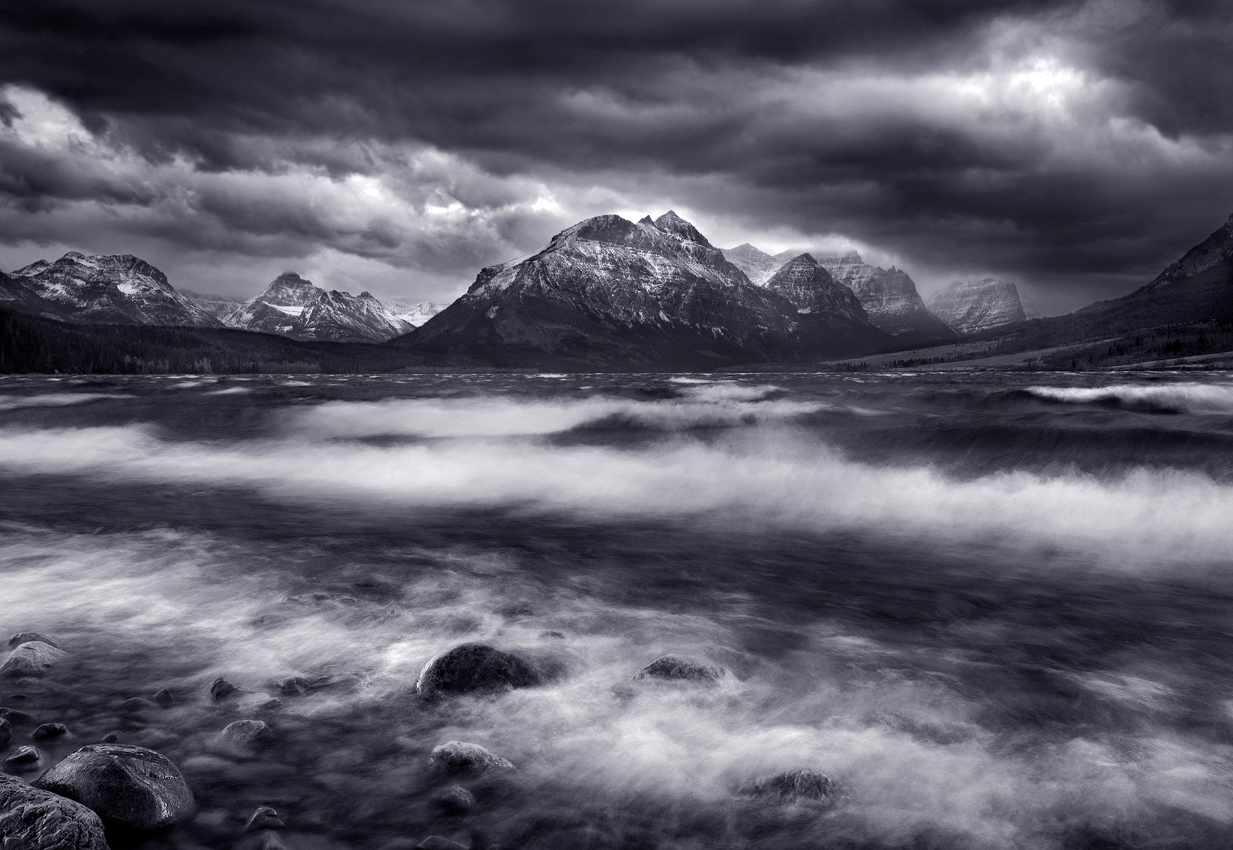 Dramatic skies and violent waters as a winter storm descends on Saint Mary lake in Glacier National Park.