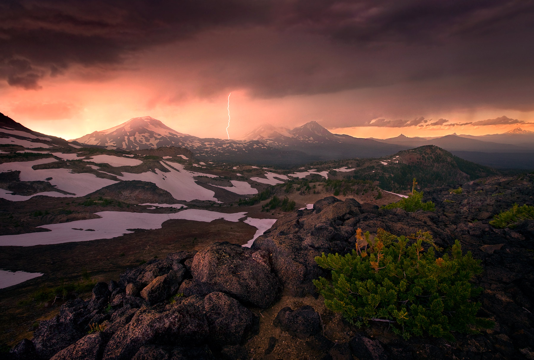 Lightning storm over Oregon's Three Sisters Peaks at sunset.