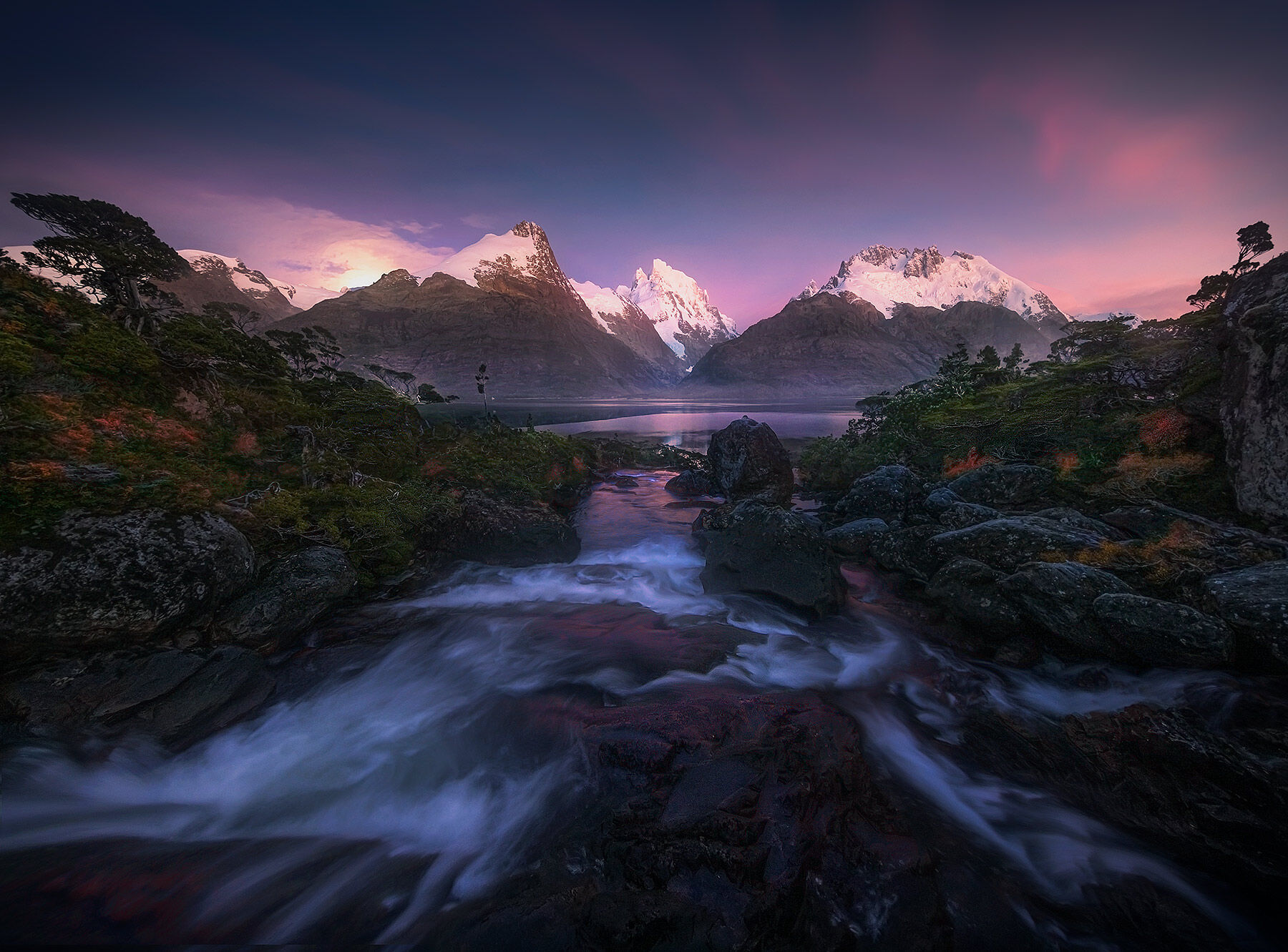 Cascades at twilight as the moon sets over a fjord in Patagonian Chile