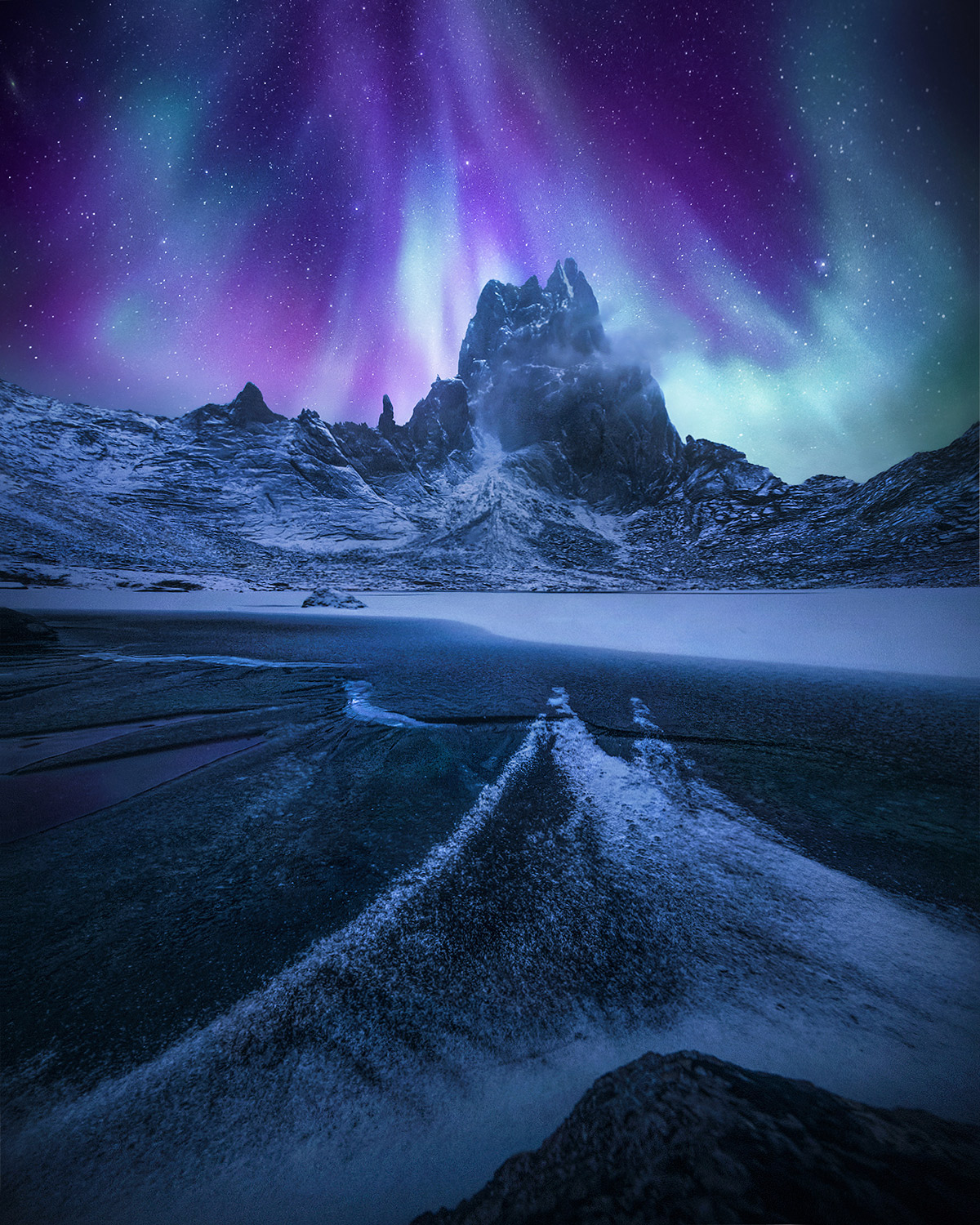 A cold night's aurora over a snow-streaked frozen lake deep in the wilderness of Tombstone Park, Yukon. &nbsp;