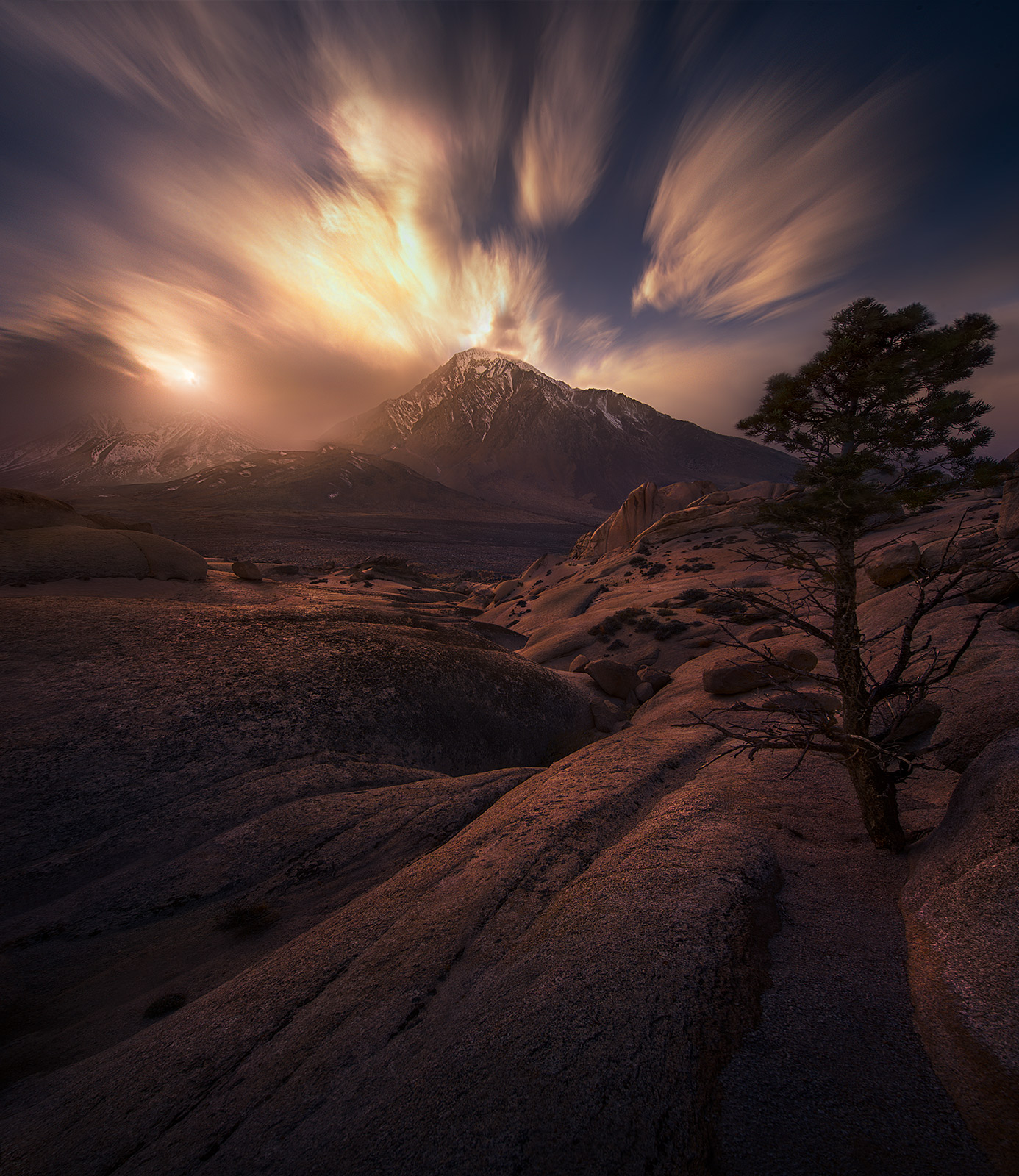 Long exopsure on wide angle clouds at sunset looking towards high Sierra peaks.&nbsp;