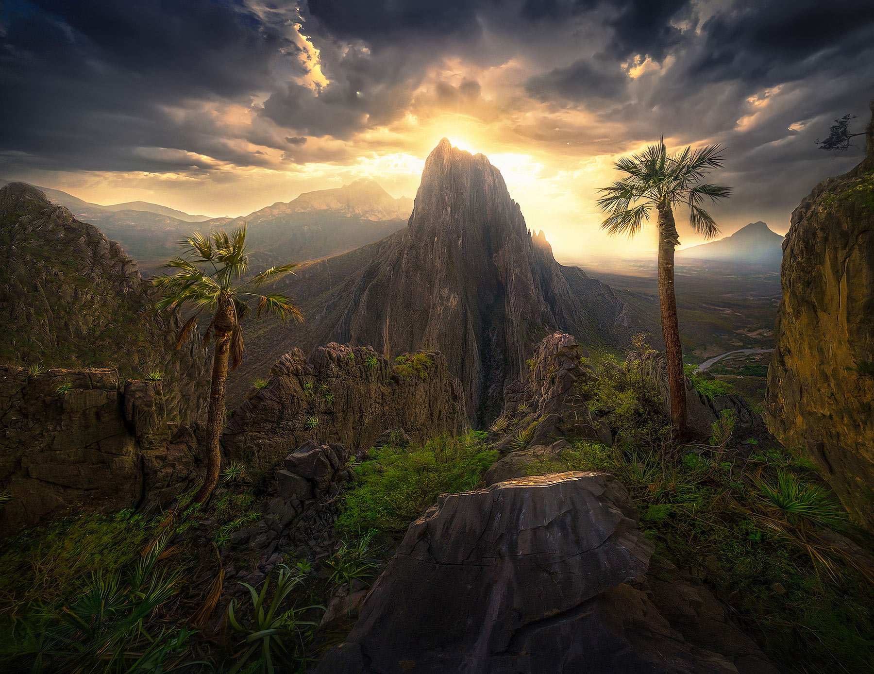 A burst of light through stormy skies over high peaks of Potrero Chico, Mexico